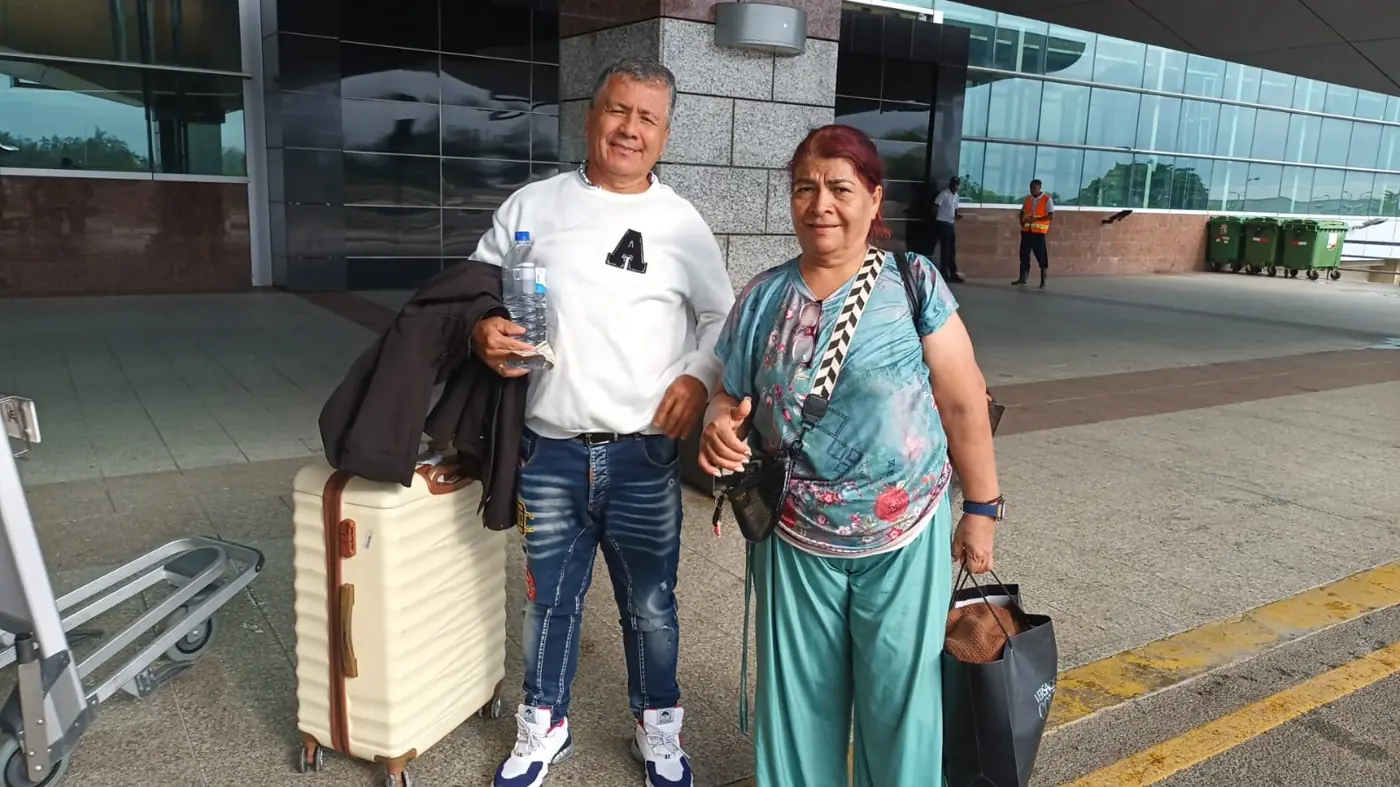 A couple with their suitcases ready for pickup