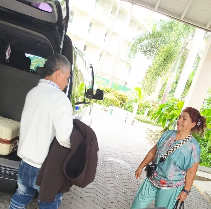 Our driver loading luggage while a traveler waits