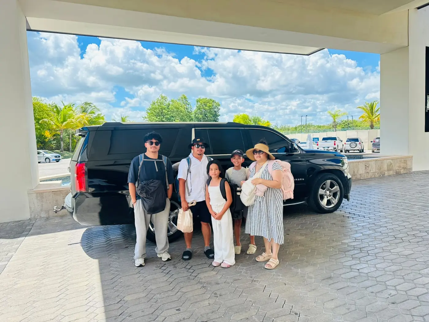 A family next to their black Suburban at Punta Cana Airport